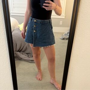 Dark wash denim skort. Wraparound with buttons.